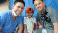 dental students with a child in a third world country clinic